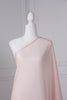 Baby pink saree draped on a mannequin. The saree has silver threading sewn throughout, giving a shimmery appearance.