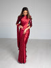 Model looking down wearing a 3/4 sleeve maroon sequin crop top and draped in a deep red satin silk saree.