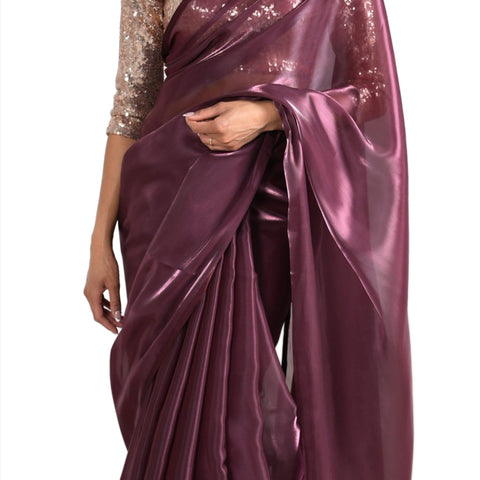 Model draped in a maroon/burgundy organza saree with maroon/burgundy satin border. Model is also wearing a rose gold 3/4 sleeve sequin crop top.